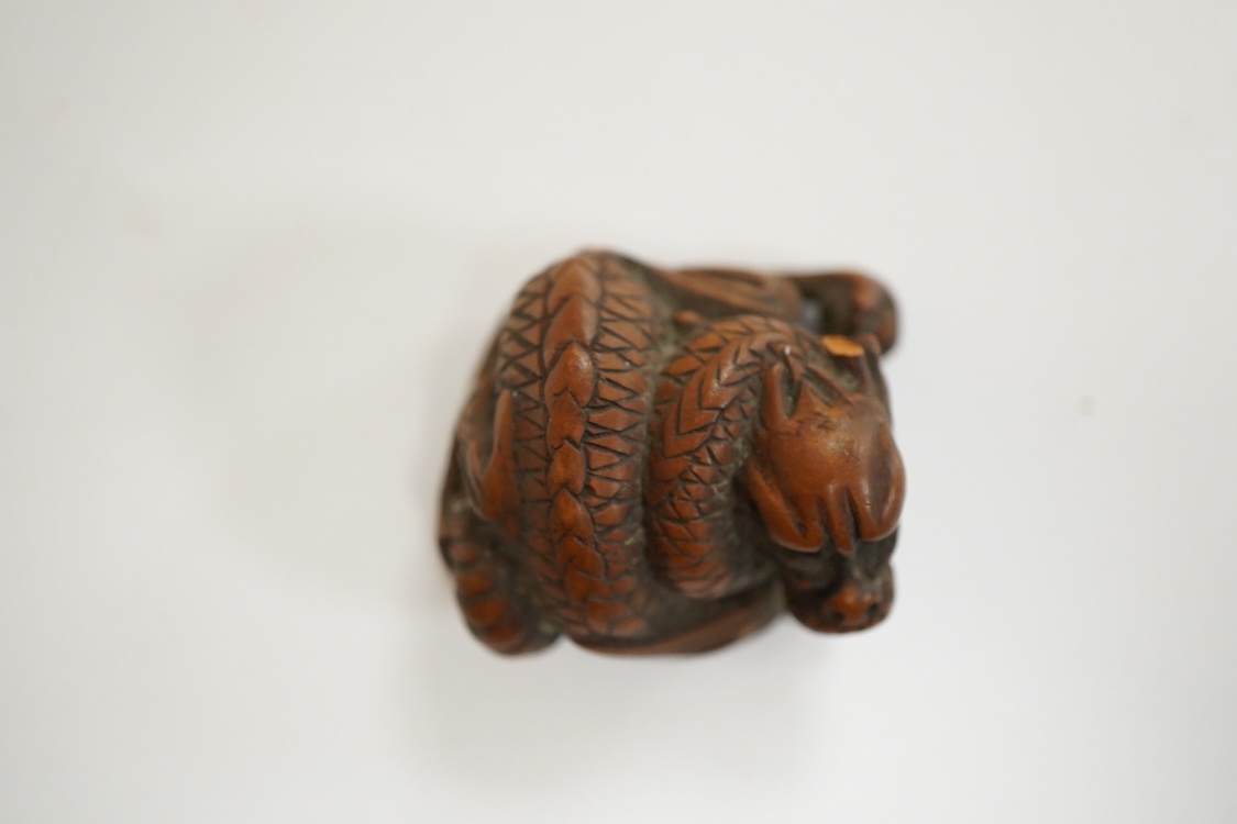 A 19th century Japanese carved wood ‘dragon’ netsuke, 4cm wide